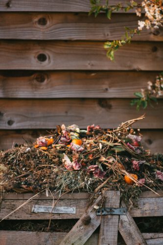 A small compost heap in a garden.